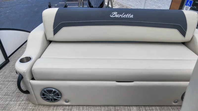 Slide: The Image of The Barletta Aria 24UC features a cream-colored bench seat with an integrated speaker and cup holder. - 10
