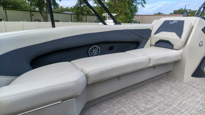 Slide: The Image of The image shows a luxurious seating area on a Barletta Aria 24UC boat, surrounded by elegant details. - 17