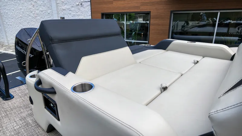 Slide: The Image of The image shows the rear of a Barletta Aria 24UC boat with comfortable lounge seating. - 9