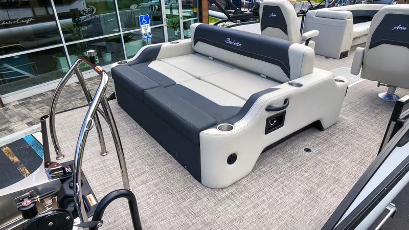 Slide: The Image of The image shows the deck of a 2027 Barletta Aria 24UC with a gray and black bench seat. - 5