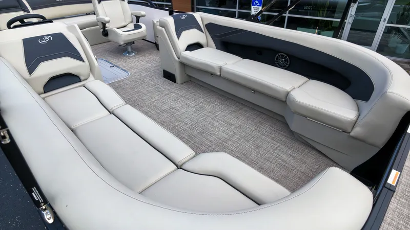 Slide: The Image of The image shows the interior of a Barletta Aria 24UC boat with sleek, light-colored upholstered seating. - 1
