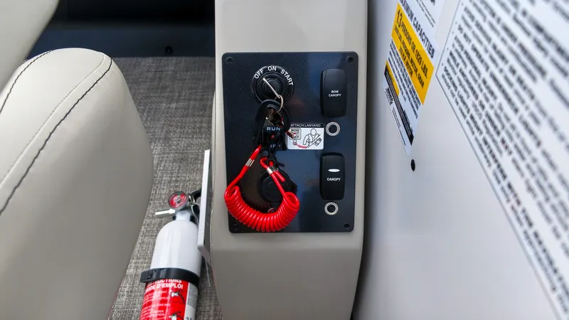 Slide: The Image of Close-up of a boat ignition switch with a red safety lanyard and a fire extinguisher nearby. - 21