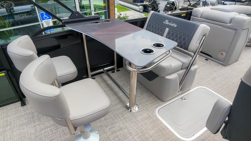 Slide: The Image of The image shows the interior of a 2027 Barletta Lusso 25UE with elegant seating and a table. - 18