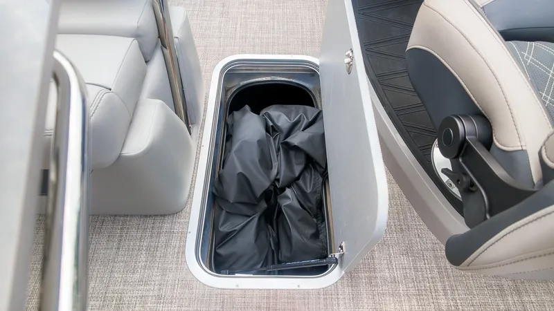 Slide: The Image of An open floor storage compartment on a boat with a black cover inside. - 19