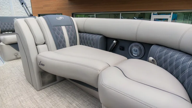 Slide: The Image of Luxurious padded seating in a modern boat with elegant stitching and speakers. - 23
