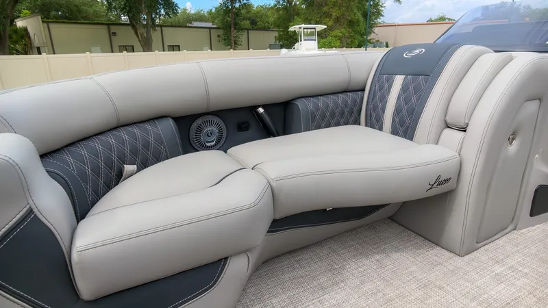 Slide: The Image of Luxurious seating area on a Barletta Lusso 25UE pontoon boat, featuring elegant gray upholstery and stylish stitching. - 26