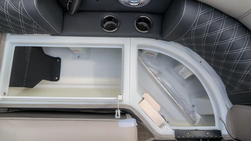 Slide: The Image of Interior view of a 2027 Barletta Lusso 25UE with storage compartment and cup holders. - 24