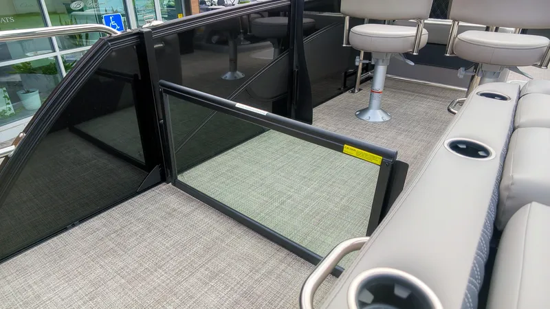 Slide: The Image of The image shows the interior of a Barletta Lusso 25UE boat with beige seating and carpeted flooring. - 32