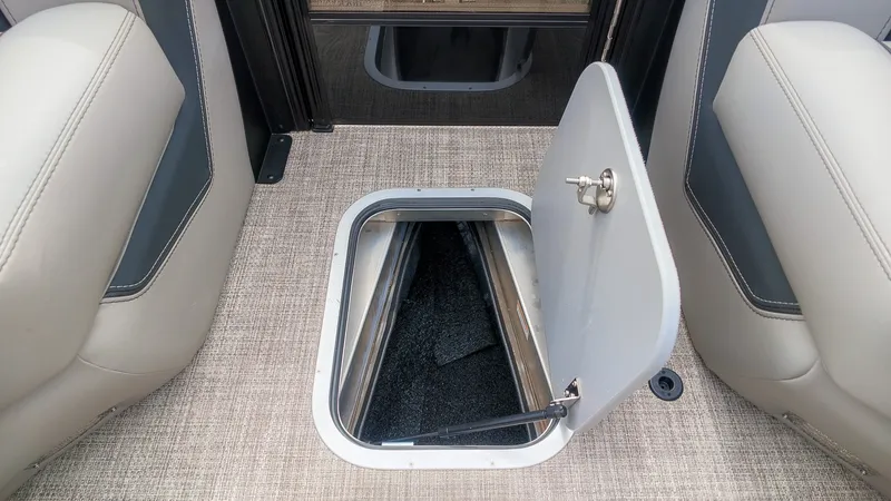Slide: The Image of An open storage compartment in the floor of a 2027 Barletta Lusso 25UE boat. - 25