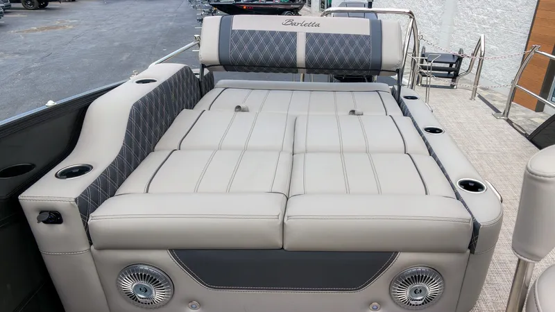 Slide: The Image of The image shows the luxurious lounge seating of a 2027 Barletta Lusso 25UE with elegant stitching. - 14