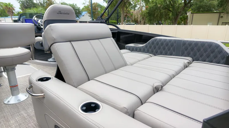 Slide: The Image of The image shows the luxurious interior of a Barletta Lusso 25UE boat with comfortable seating. - 16