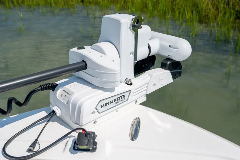 Slide: The Image of Minn Kota trolling motor on 2025 Caymas 26 HB boat in shallow water. - 18