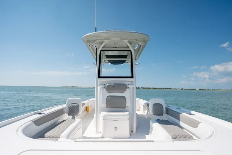 Slide: The Image of 2025 Caymas 26 HB boat on calm water under clear blue sky. - 17