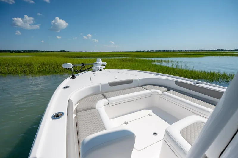 Slide: The Image of 2025 Caymas 26 HB boat on serene water with lush green marshland. - 16