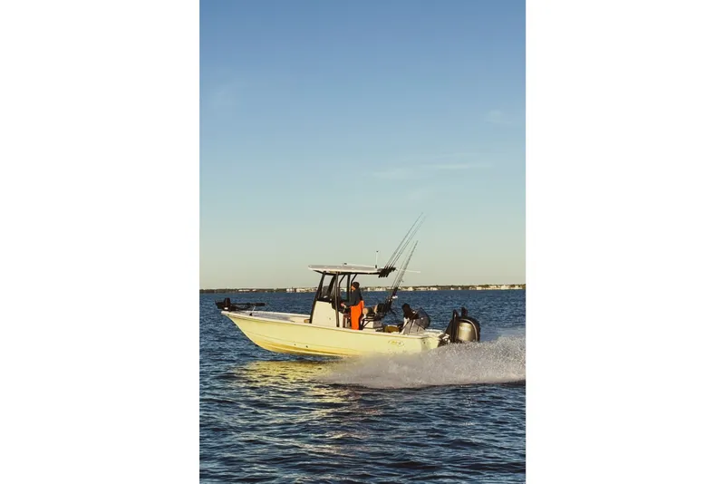Slide: The Image of 2025 Sea Hunt BX22BR boat cruising on open water under clear skies. - 3