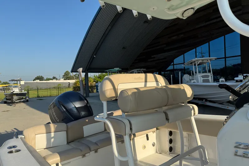 Slide: The Image of 2016 NauticStar 2302 Legacy boat with Yamaha engine, parked near modern building. - 20
