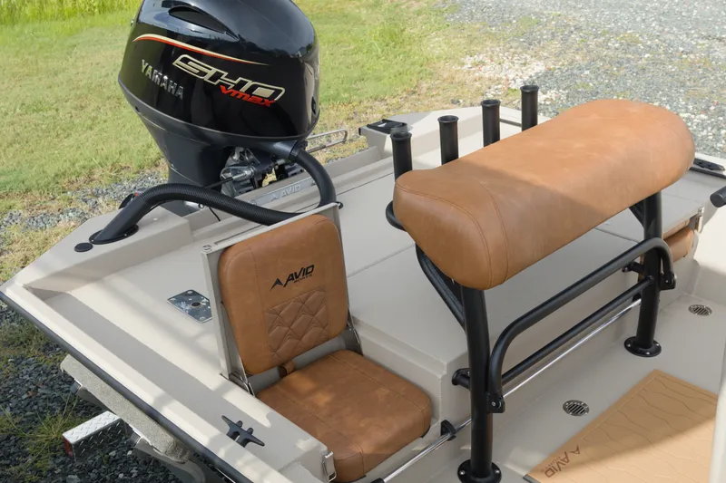 Slide: The Image of 2027 Avid 20 Rogue CC boat interior with Yamaha engine, featuring tan leather seating. - 20