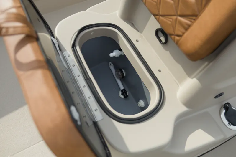 Slide: The Image of Open storage compartment in 2027 Avid 20 Rogue CC boat with brown seating. - 16
