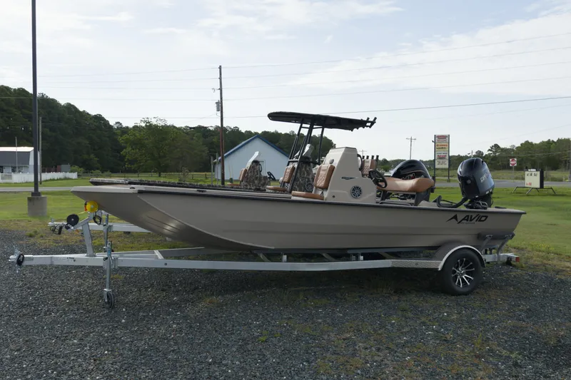 The Image of 2027 Avid 20 Rogue CC boat on trailer, parked outdoors. - 1