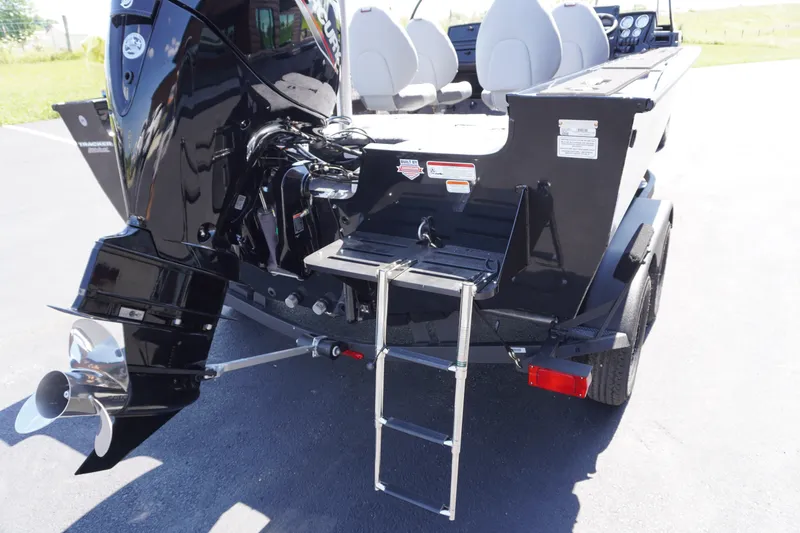 Slide: The Image of 2027 Tracker Targa V-18 Combo boat rear view with motor and ladder. - 24