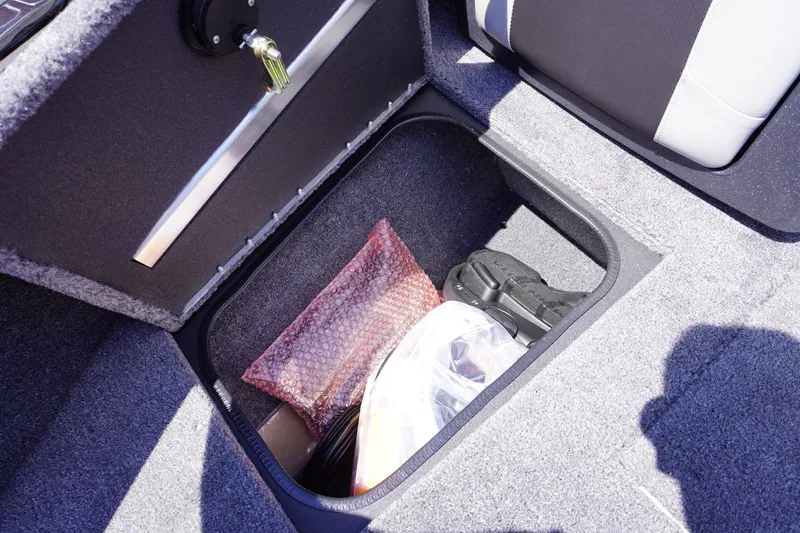 Slide: The Image of Storage compartment in 2027 Tracker Targa V-18 Combo boat, featuring organized gear and accessories. - 16