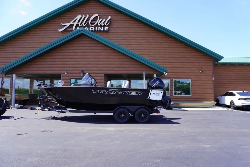 The Image of 2027 Tracker Targa V-18 Combo boat on trailer outside All Out Marine store. - 1