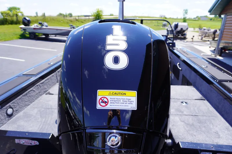 Slide: The Image of 2027 Tracker Targa V-18 Combo boat with a 150 HP engine, parked outdoors. - 23