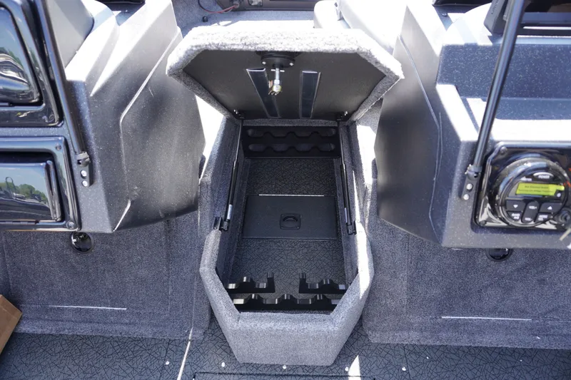 Slide: The Image of 2027 Tracker Targa V-18 Combo boat storage compartment with open lid, showcasing interior space. - 20
