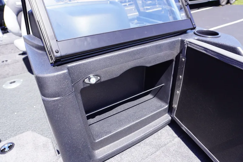 Slide: The Image of 2027 Tracker Targa V-18 Combo boat storage compartment with open door and cup holder. - 18