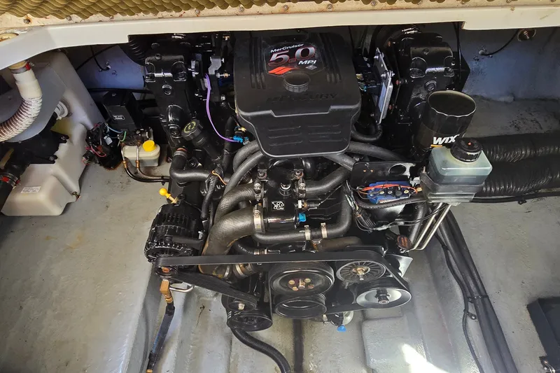 Slide: The Image of Engine compartment of a 2003 Sea Ray Sundancer 260 boat, featuring a Mercury 5.0 MPI engine. - 27