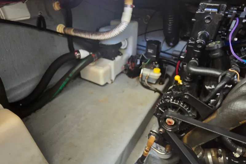 Slide: The Image of Engine compartment of a 2003 Sea Ray Sundancer 260 boat, showing mechanical components. - 29