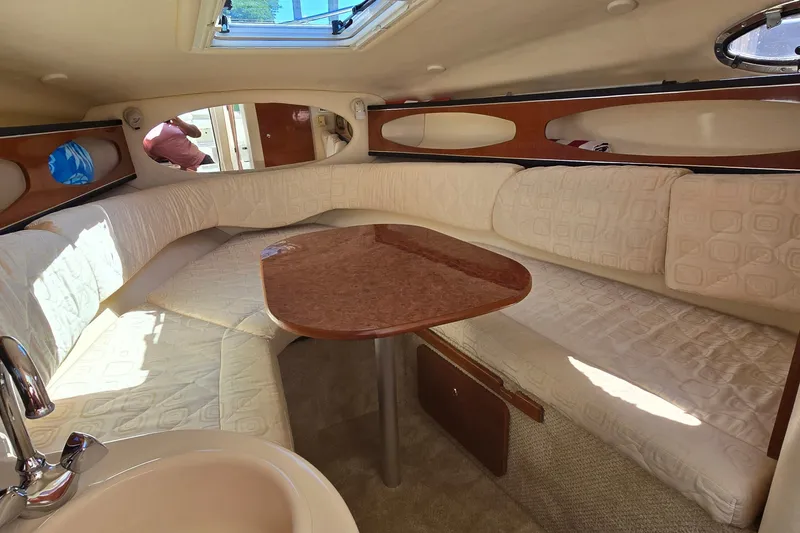Slide: The Image of Interior of 2003 Sea Ray Sundancer 260 with cozy seating and table. - 17