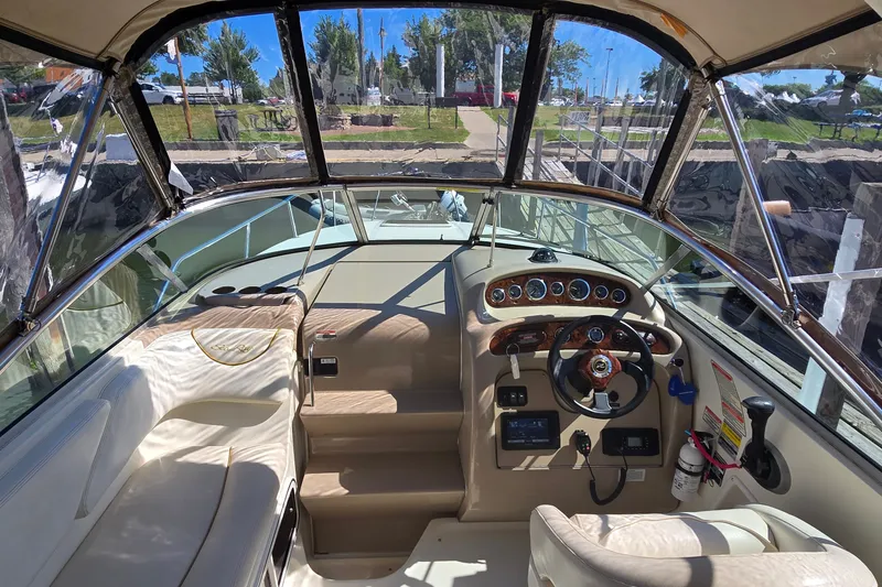 Slide: The Image of Interior view of 2003 Sea Ray Sundancer 260 boat cockpit with steering wheel and dashboard. - 15
