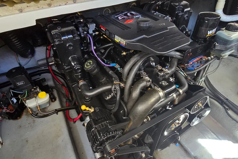 Slide: The Image of Engine compartment of a 2003 Sea Ray Sundancer 260 boat, showcasing detailed components. - 30