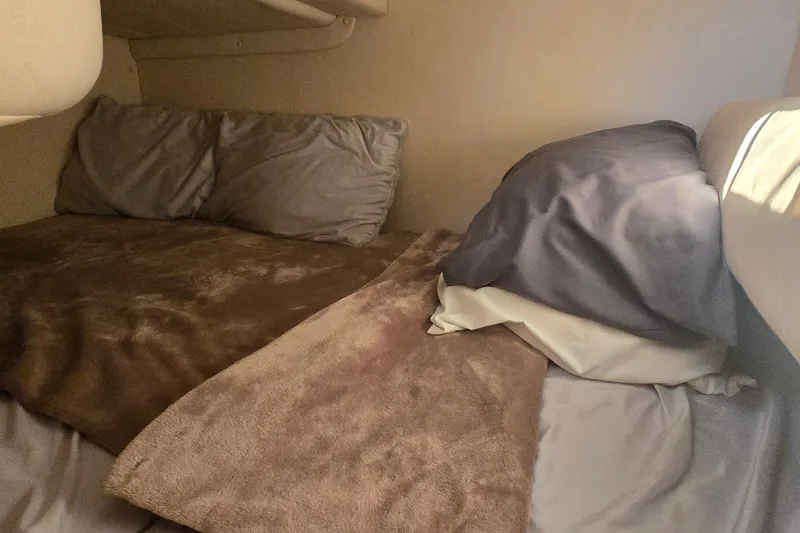 Slide: The Image of Cozy sleeping area in a 2003 Sea Ray Sundancer 260 boat cabin. - 22