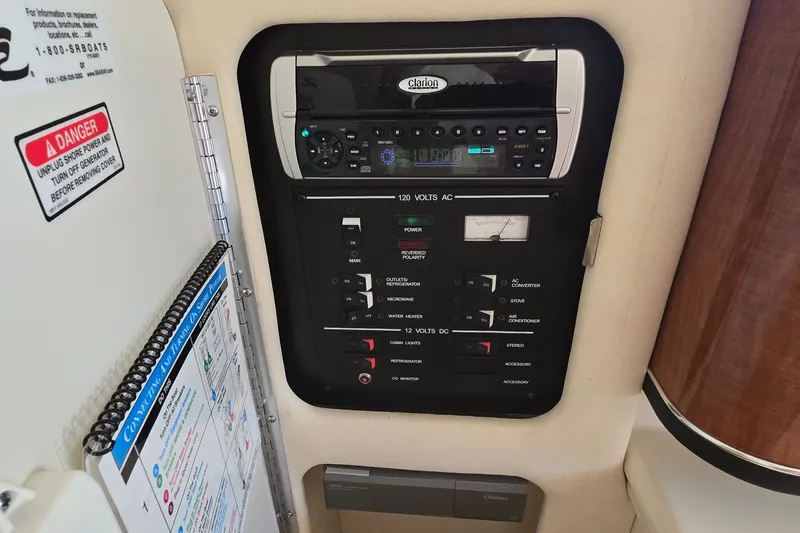 Slide: The Image of Control panel of a 2003 Sea Ray Sundancer 260 boat, featuring Clarion audio system. - 21