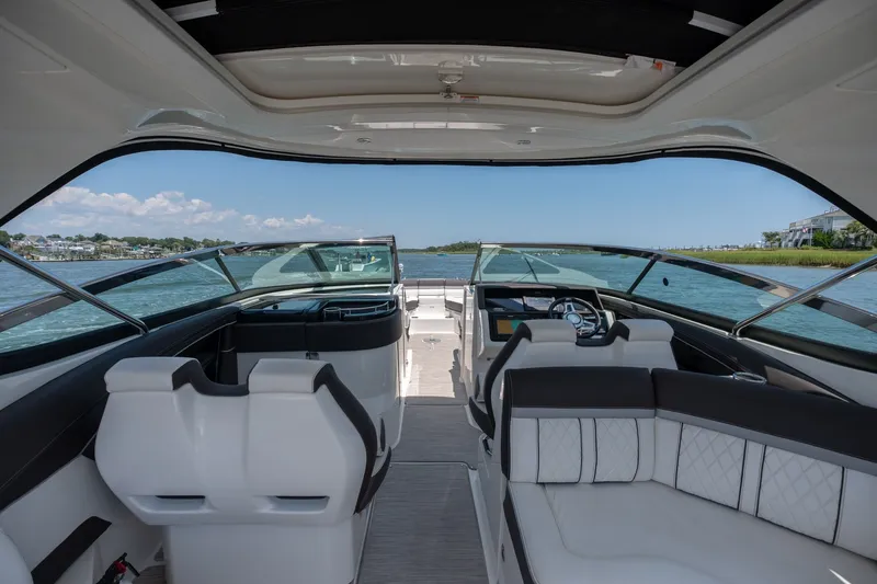 Slide: The Image of Interior view of 2017 Sea Ray SLX 350 boat, featuring luxurious seating and modern dashboard. - 25