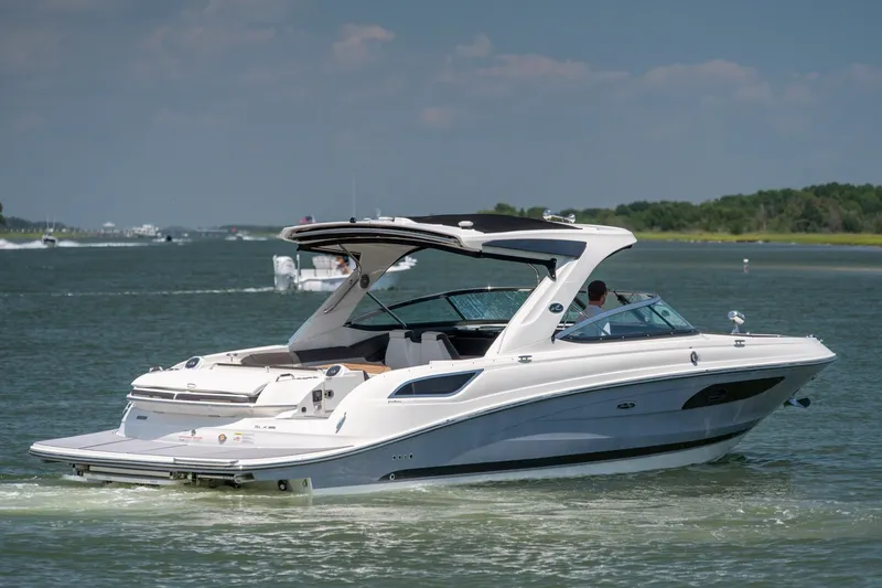 Slide: The Image of 2017 Sea Ray SLX 350 boat cruising on a sunny day in open water. - 1