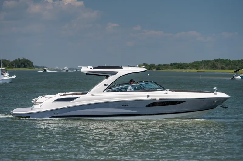 The Image of 2017 Sea Ray SLX 350 cruising on a calm lake under a clear blue sky. - 0