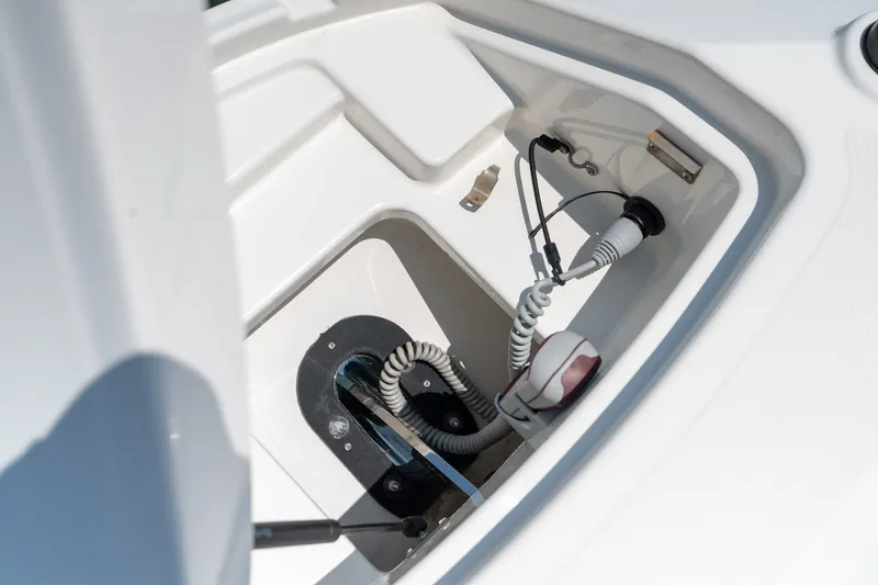 Slide: The Image of Storage compartment of a 2017 Sea Ray SLX 350 boat, featuring coiled cables. - 16
