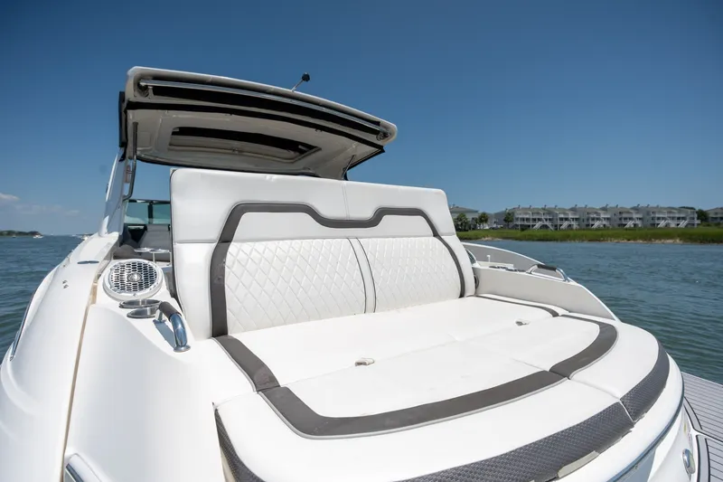 Slide: The Image of 2017 Sea Ray SLX 350 boat with luxurious seating on a sunny day by the water. - 40