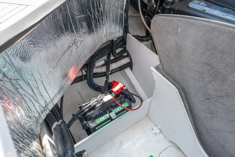 Slide: The Image of 2017 Sea Ray SLX 350 boat battery compartment with wiring and insulation. - 46