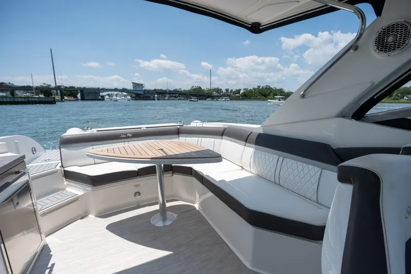 Slide: The Image of Luxurious 2017 Sea Ray SLX 350 boat interior with elegant seating and scenic water view. - 34