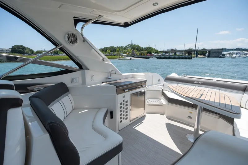 Slide: The Image of Luxurious 2017 Sea Ray SLX 350 boat interior with seating and table, overlooking serene waters. - 26