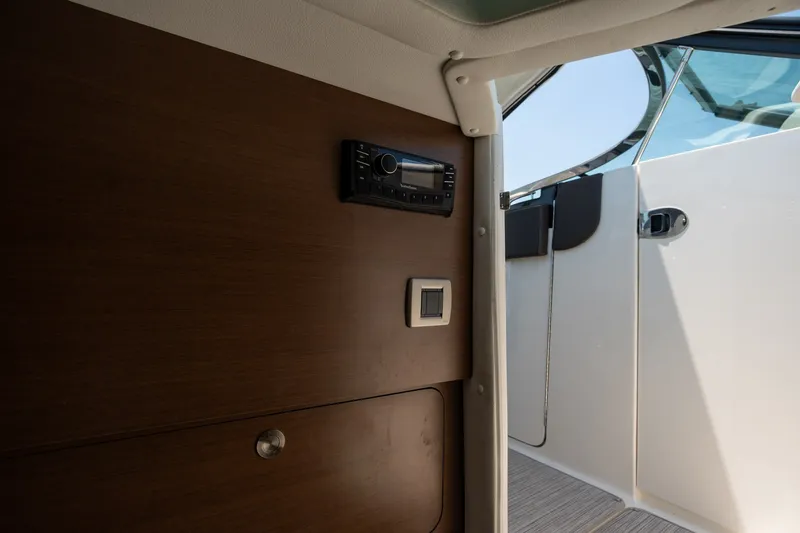 Slide: The Image of Interior view of 2017 Sea Ray SLX 350 boat with wooden panel and control system. - 32