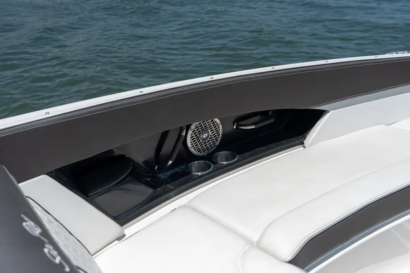 Slide: The Image of 2017 Sea Ray SLX 350 boat interior with speaker and cup holders by the water. - 12