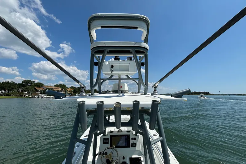 Slide: The Image of 2020 Yellowfin 26 Hybrid boat on water, featuring a tower and clear blue sky. - 14