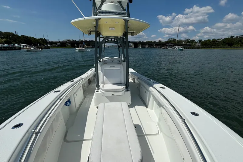 Slide: The Image of 2020 Yellowfin 26 Hybrid boat on calm water under a blue sky. - 15