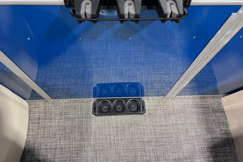 Slide: The Image of Interior view of 2026 SunCatcher Select 20F boat with blue paneling and cup holders. - 14