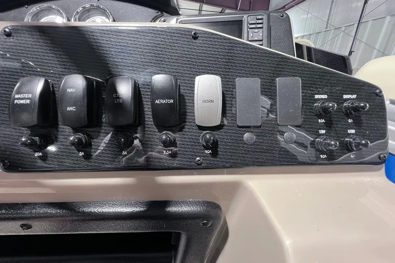 Slide: The Image of Control panel of 2026 SunCatcher Select 20F boat with various switches and dials. - 26